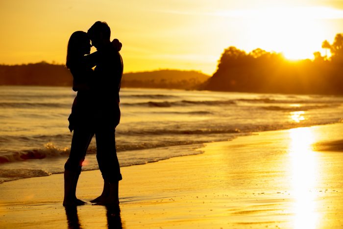 Silhouette of a couple on the beach at sunset